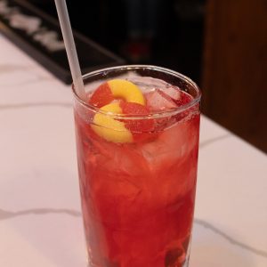 peach ring cocktail with peach ring candy garnishes